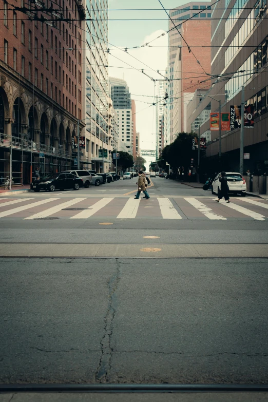 pedestrians and bicycles are crossing a crosswalk on a city street
