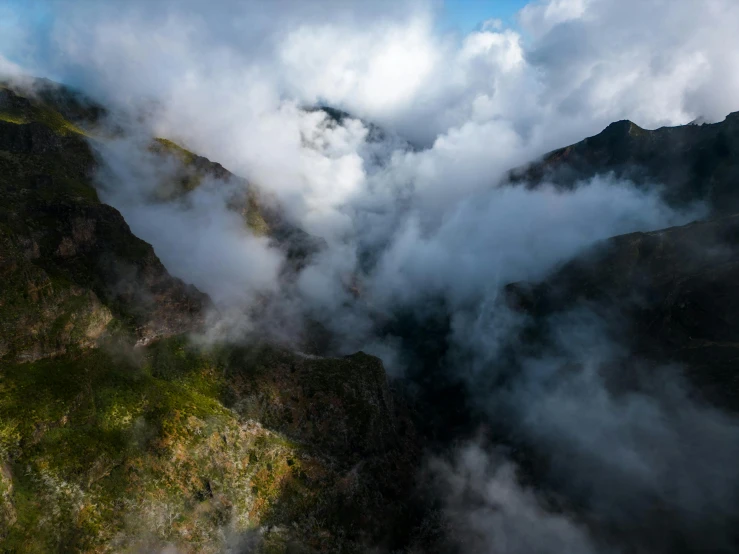 an aerial view of green and brown mountains