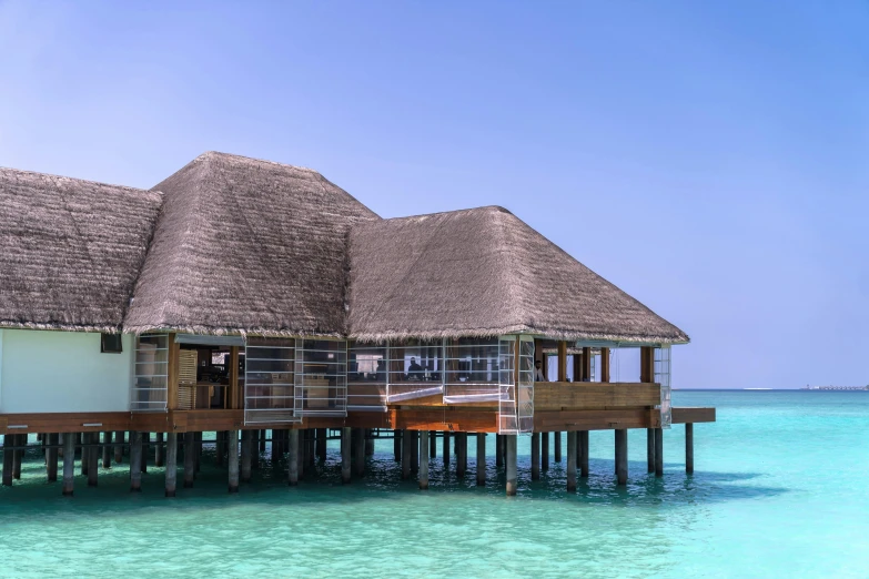 a home on stilts on water with sky