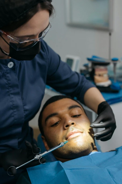 a person is being examined with a dentist's tool