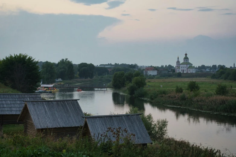 some buildings on the side of a river with buildings near by