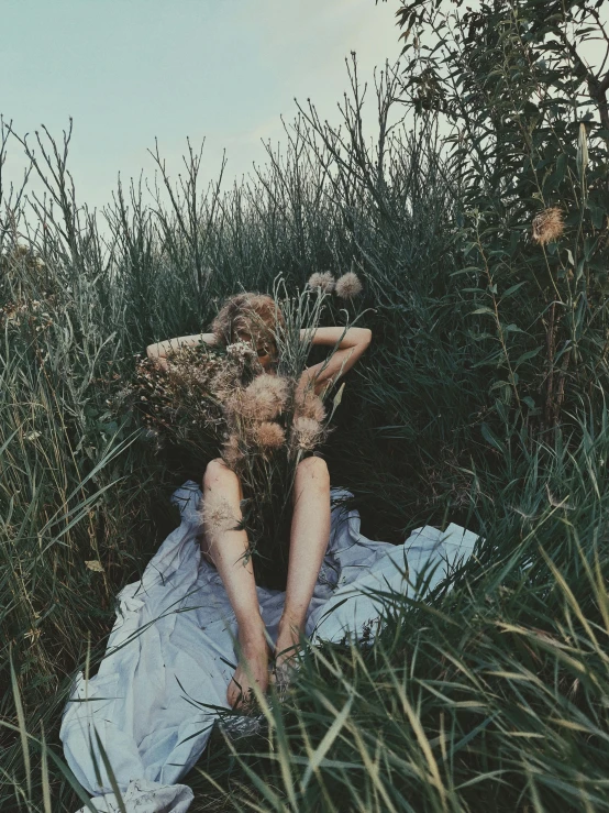 a  girl lying on a white piece of cloth