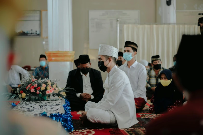 an indian wedding ceremony with grooms and bride