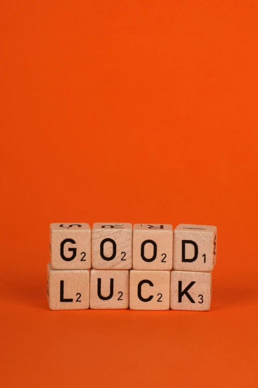 an arrangement of scrabble blocks spelling the word good luck
