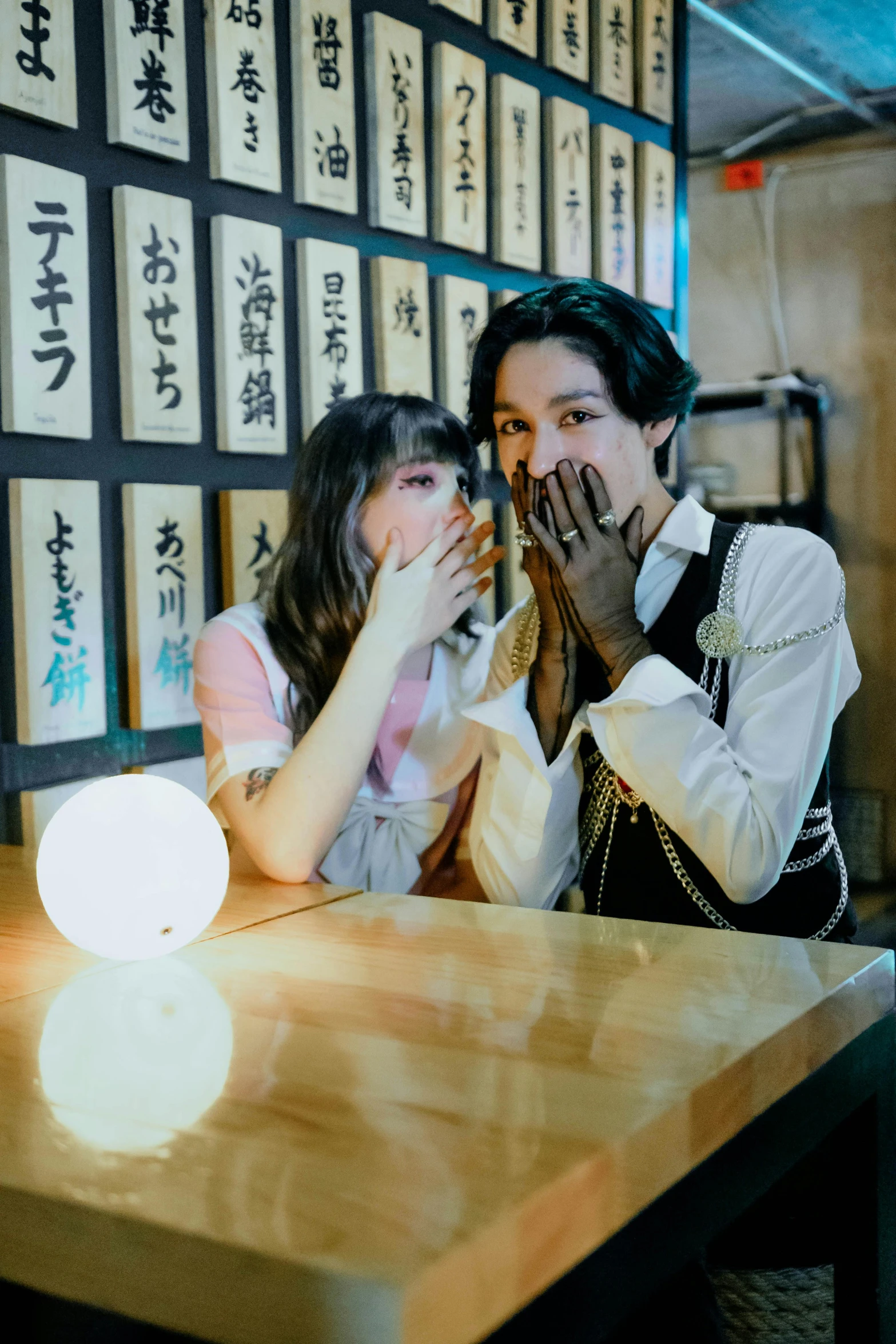 two people sitting at a table with many signs