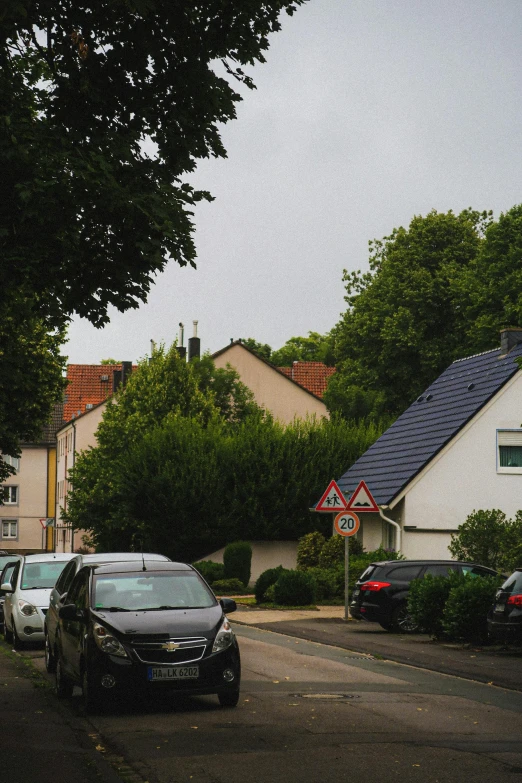 a row of houses in a neighborhood with one car parked along the road