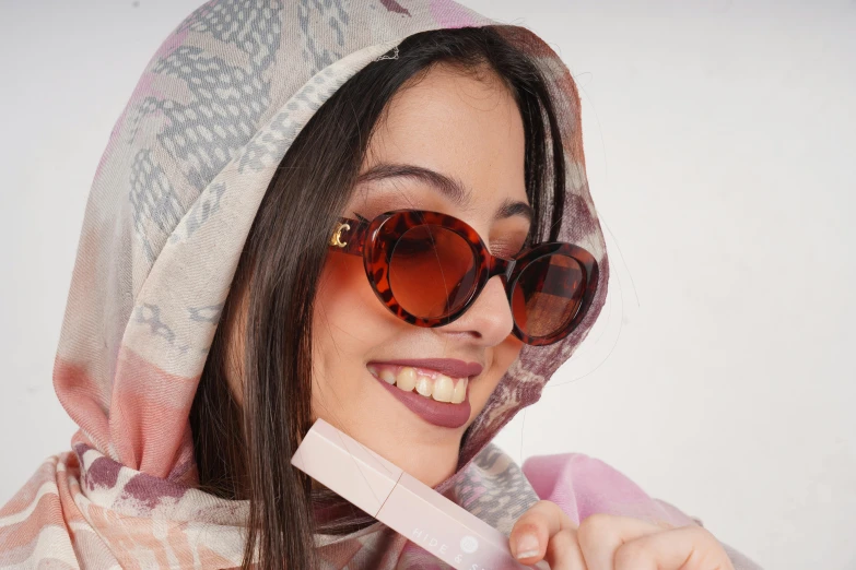 a woman holding up a pink wii game controller