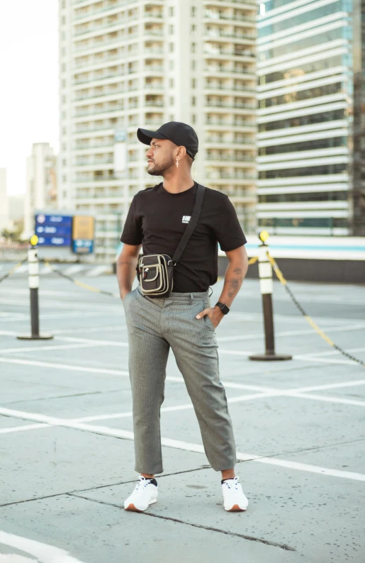 a man posing in an empty parking lot