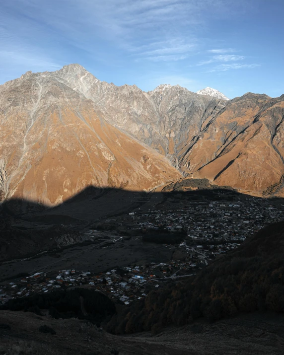 a mountain range with snow capped mountains in the background