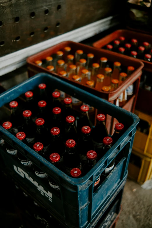 a box filled with bottles of beer and two boxes with bottles sitting behind them