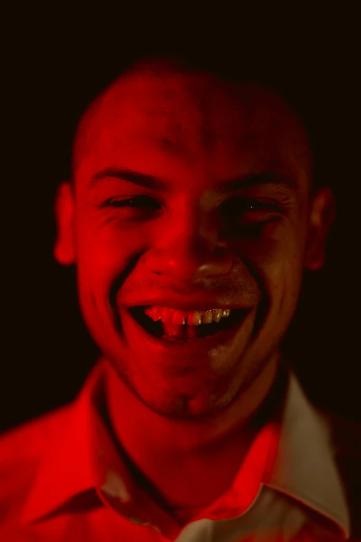 a man with a red face is smiling