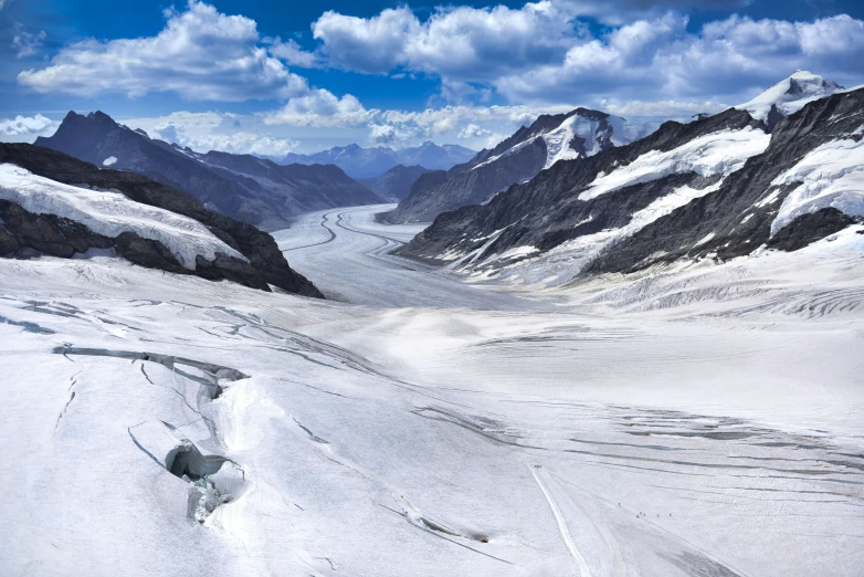 there is a long snow trail up a snowy hill