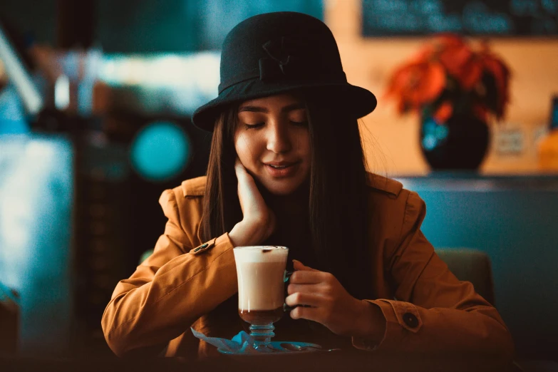 woman in a black hat with a beverage