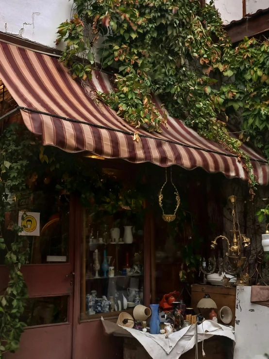 a house that has a awning and a chair in front