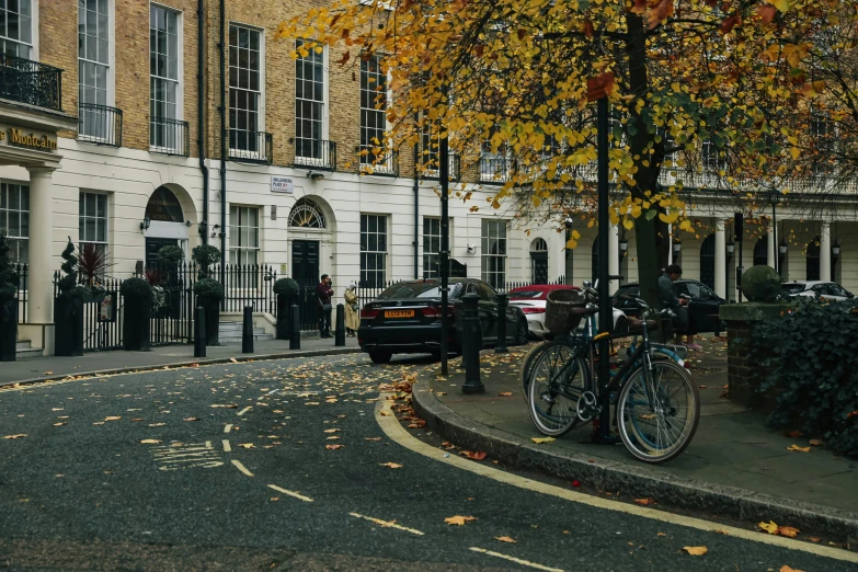 an outside s of many buildings with several bicycles parked on a road