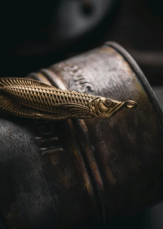 the gold feather brooch is on the back of a leather case