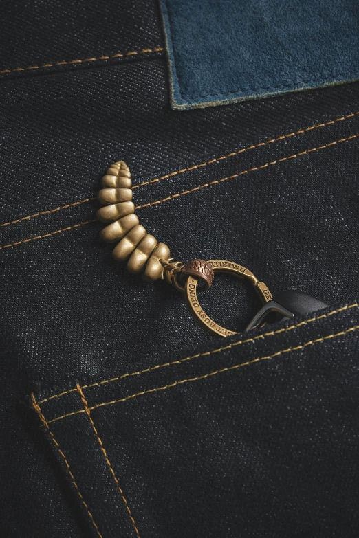 a key chain is in the pocket of some blue jeans