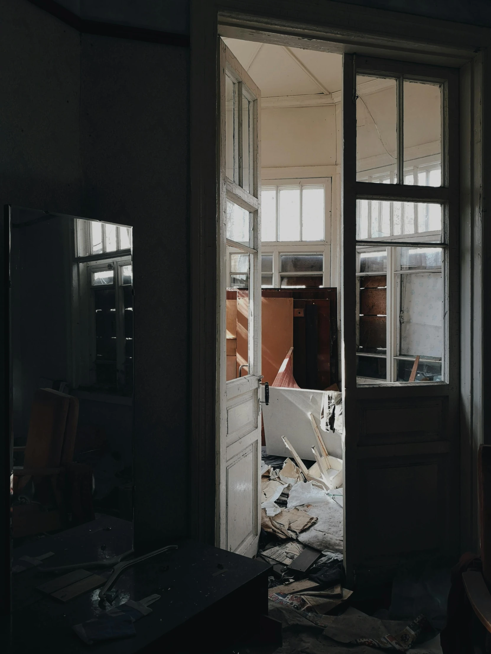 the front door to a home with broken windows