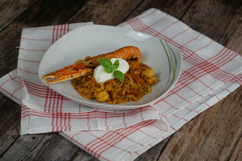 a bowl with food and white cream on it