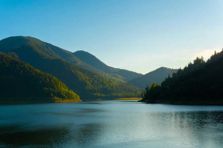 a scenic view of mountains near the water