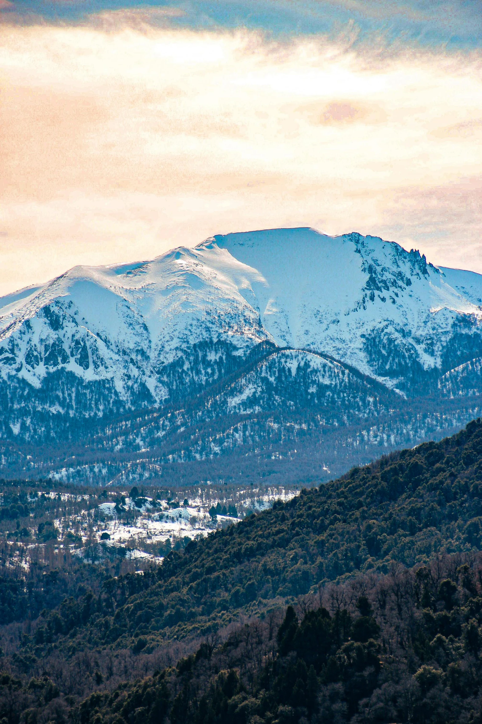 a snow covered mountain range as it is seen