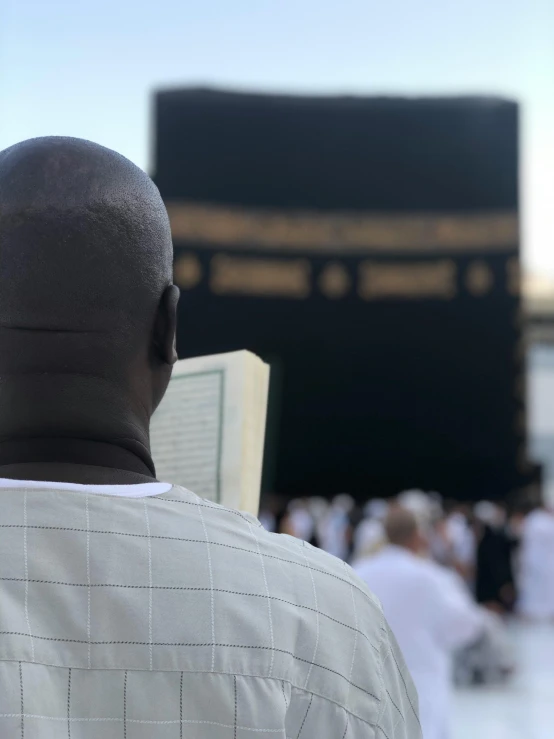 a man standing next to an arch of worship