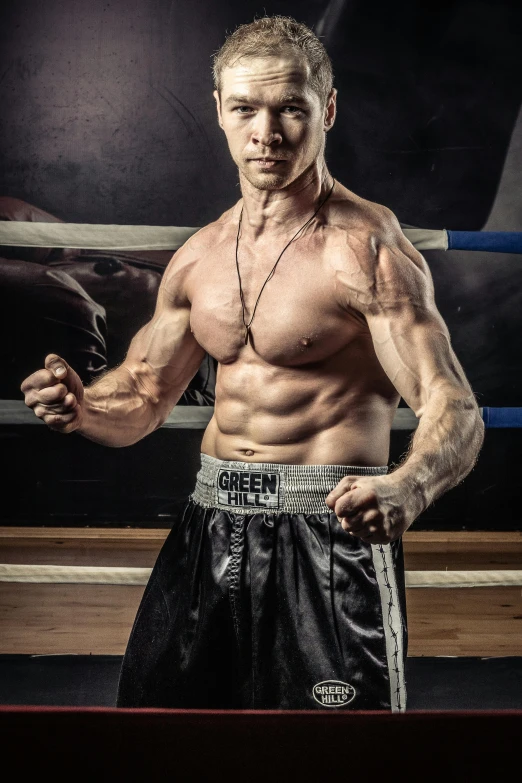 a man standing in a boxing ring holding a glove