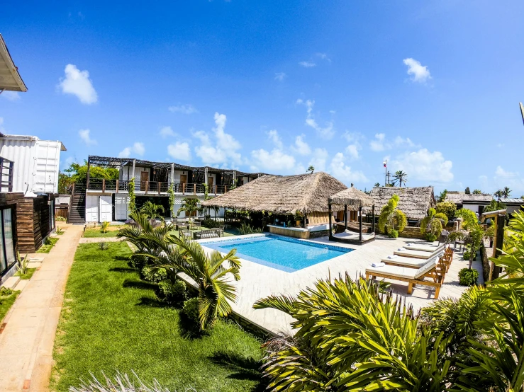 a house with a pool and green grass