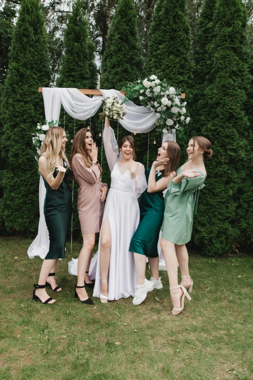 women are all together on the lawn during a wedding