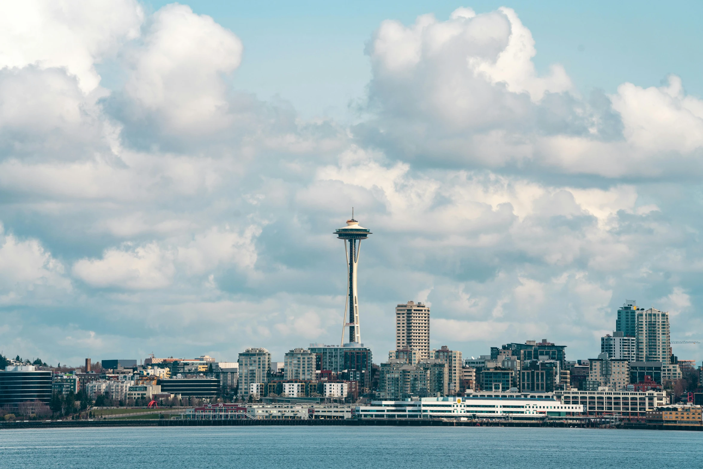 a body of water with buildings in the background