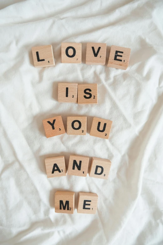 scrabble letters spelling love is you and me