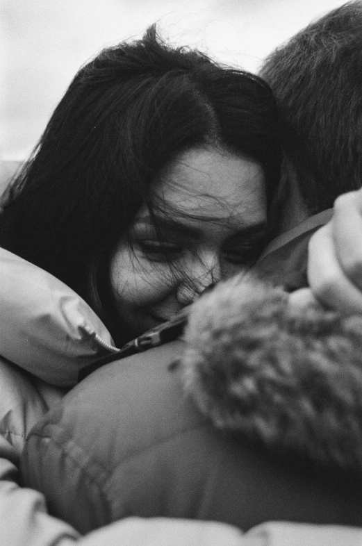 a woman holding a baby and hugging her arm