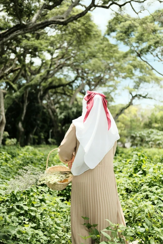 a person walking in the woods with a straw basket