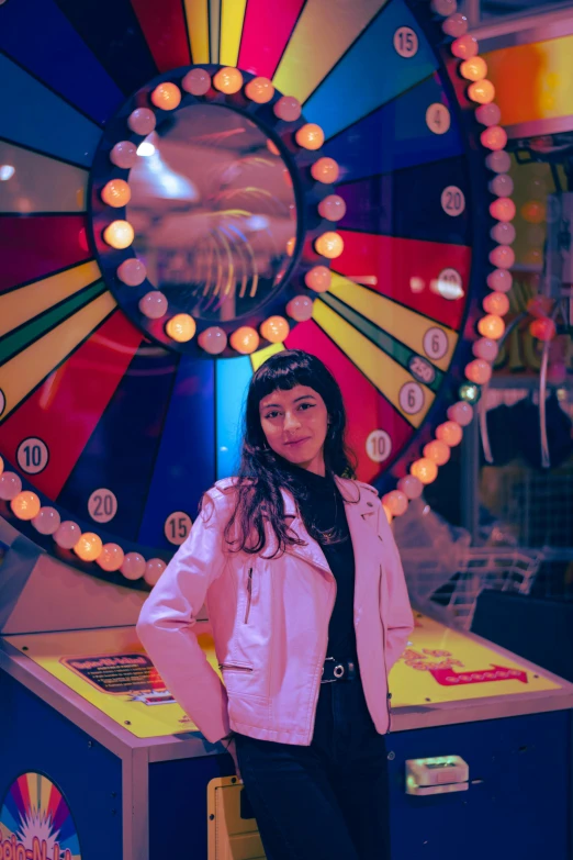 girl in front of a brightly colored wheel of fortune game