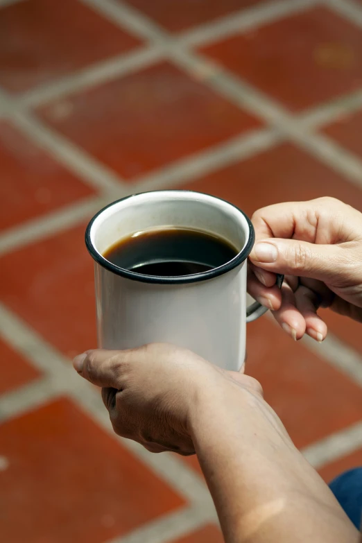 two people that are holding up some kind of cup