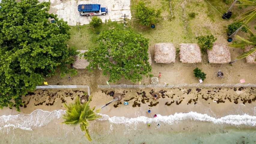 a bird's eye view of a beach with sand and blue ocean water