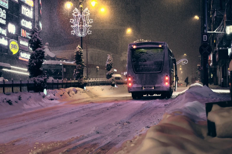 a city bus is driving down a snowy street