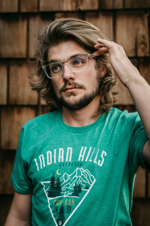 a man wearing glasses posing for a picture