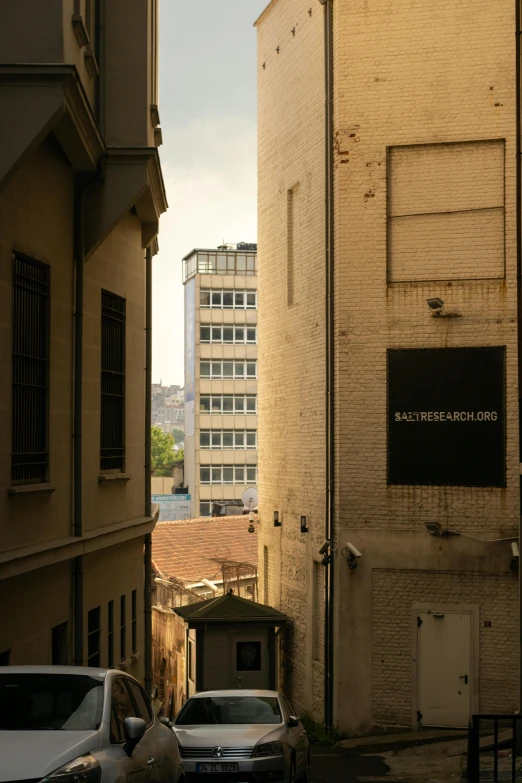 cars parked in the alley next to buildings