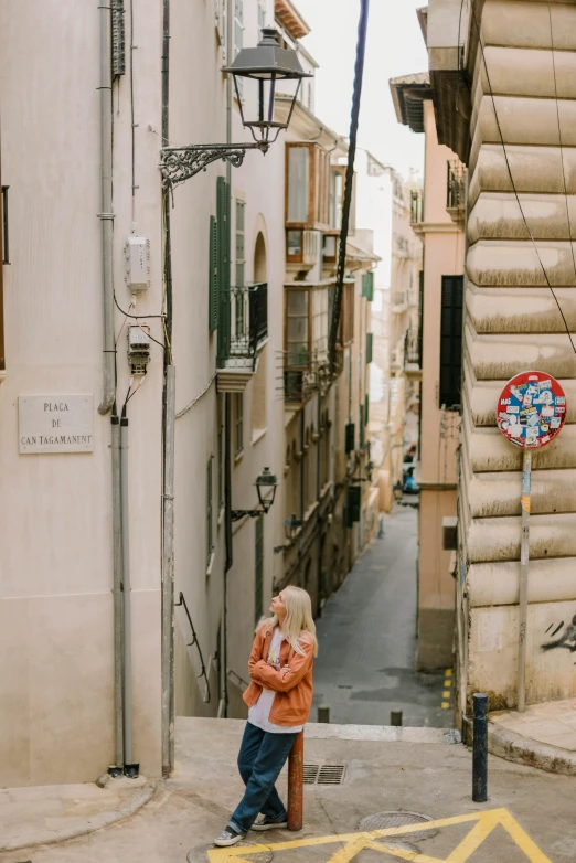 a child standing in an alley by a sign