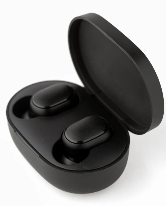 two black earbuds one has a circular cover and one has a single bluetooth