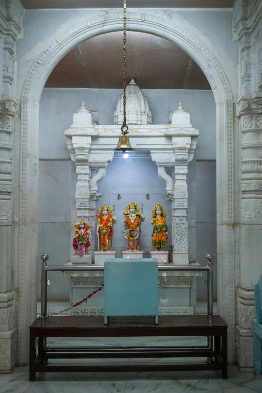 an altar with statues and bells is shown in this ornate building