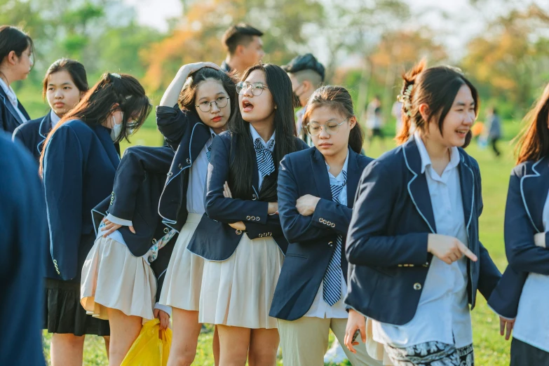 a group of students stand in a line, with each other