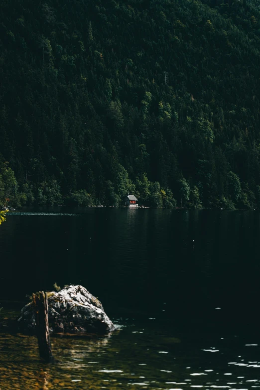 a lone boat floats down a river in the sun