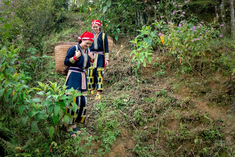 some people on a hill with a basket in their hand