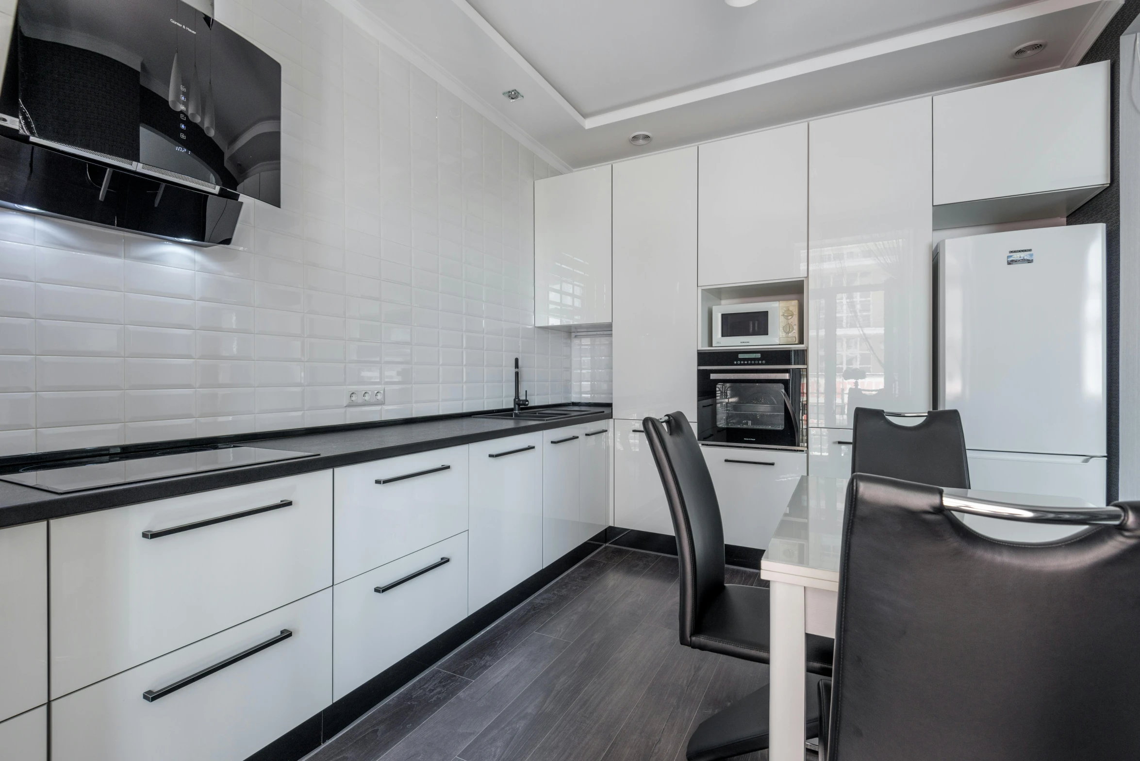 a kitchen that has a refrigerator and oven in it