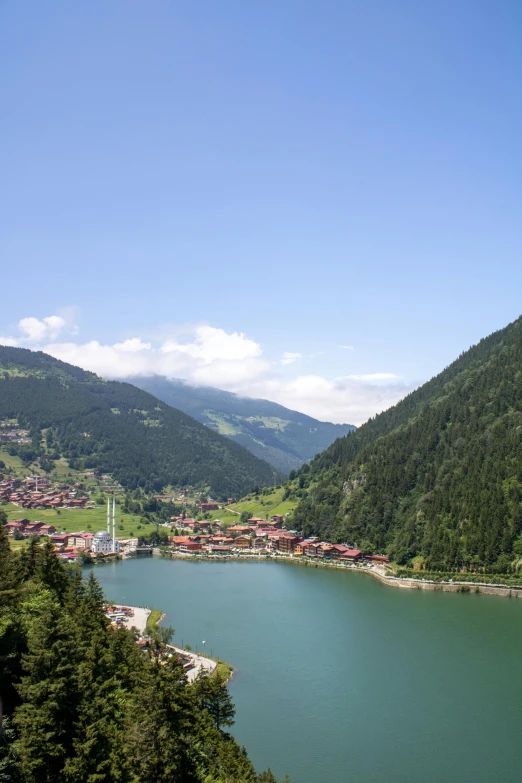 the mountains overlook a lake with a town in the middle