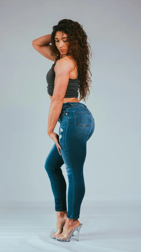 a women wearing high - rise jeans standing up