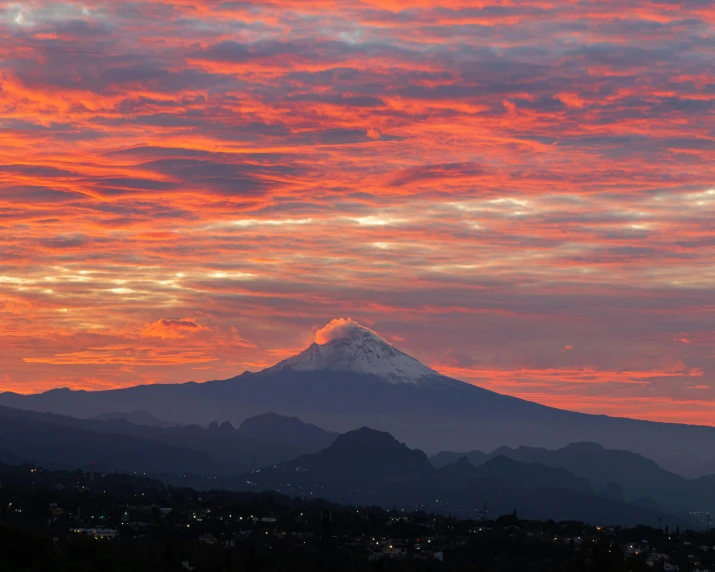 a view of some very pretty mountains at sunset