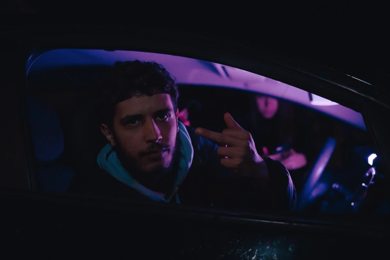 man in the car making stop sign to someone else